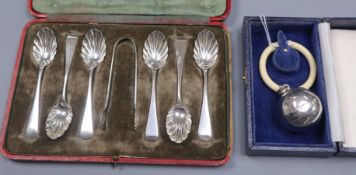 A cased set of George V silver teaspoons and tongs and a cased modern silver child's rattle.