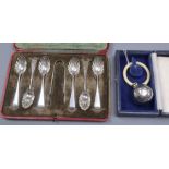 A cased set of George V silver teaspoons and tongs and a cased modern silver child's rattle.