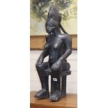 A Yoruba ebonised wood figure of a seated woman height 70cm