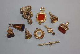 Seven assorted 19th century and later yellow metal overlaid fob seals, propelling pencil, watch