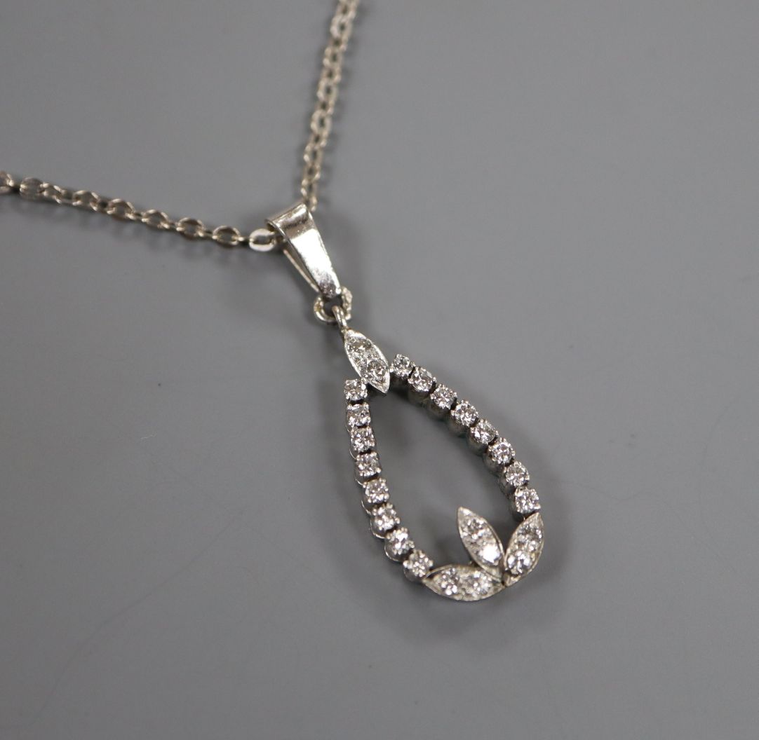 A white metal and diamond pear shaped openwork pendant, on a 14k white metal chain, pendant 20mm.