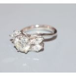 An 18ct white metal and single stone diamond ring, with marquise cut diamond set shoulders, the