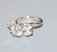 An 18ct white metal and single stone diamond ring, with marquise cut diamond set shoulders, the