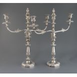 A pair of 19th century Sheffield plate two branch three light candelabra, with engraved crest, 52.