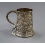 A George III later embossed silver mug, Charles Hougham, London, 1790, 12cm, 9 oz.