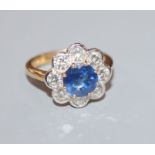 A modern 18ct gold, sapphire and diamond cluster flower head ring, size O.