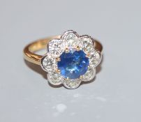 A modern 18ct gold, sapphire and diamond cluster flower head ring, size O.