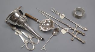 A George III silver mote spoon, a napkin ring, a tea strainer, pair of plated 'sword' skewers, a