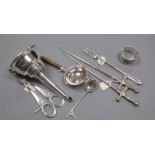 A George III silver mote spoon, a napkin ring, a tea strainer, pair of plated 'sword' skewers, a