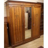 A large late Victorian pitched pine three door compactum wardrobe W.188cm