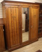 A large late Victorian pitched pine three door compactum wardrobe W.188cm