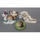 A Russian porcelain figure of a goalkeeper and a Russian porcelain inkwell and a box