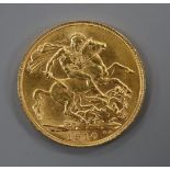 An Edward VII gold 1910 gold full sovereign.