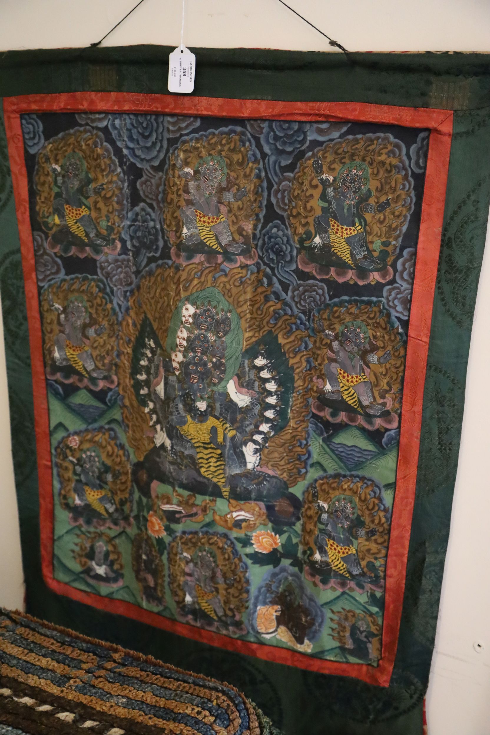 A thangka depicting a Buddhist wrathful deity, Tibet, first half 20th century, surrounded other - Image 2 of 3