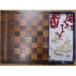 A 19th century ivory chess set and a Victorian inlaid rosewood games board