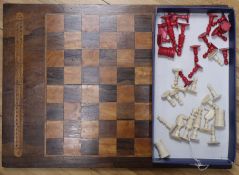 A 19th century ivory chess set and a Victorian inlaid rosewood games board