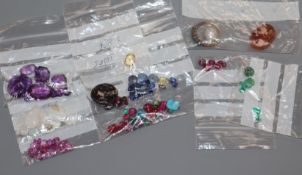 A collection of assorted unmounted gem stones, including white opal, amethyst, turquoise and