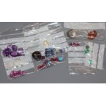 A collection of assorted unmounted gem stones, including white opal, amethyst, turquoise and