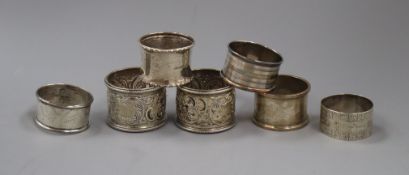 A pair of late Victorian silver napkin rings and five other silver napkin rings.