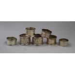 A pair of late Victorian silver napkin rings and five other silver napkin rings.