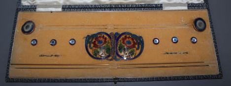 A cased early 20th century metal and enamel hatpin, buckle and button set.