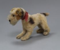 A Steiff dog, original collar, button in ear 1950's height 15cm