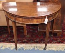 A George III inlaid mahogany demi-lune folding card table