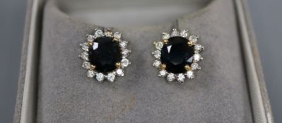 A pair of sapphire and diamond cluster earrings, yellow and white metal setting, with Gems Gallery