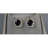 A pair of sapphire and diamond cluster earrings, yellow and white metal setting, with Gems Gallery