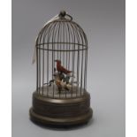 A clockwork musical singing bird automaton, the brass cage containing two birds with metal