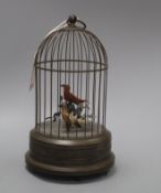 A clockwork musical singing bird automaton, the brass cage containing two birds with metal