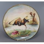 A ceramic charger painted with a Jacana standing on a lily pad by H. Deakin, Dia 32cm (worn)