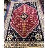 A Persian blue and red medallion rug 300 x 200cm