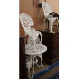A cast aluminium painted garden table and four chairs Table diameter 69cm