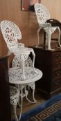 A cast aluminium painted garden table and four chairs Table diameter 69cm