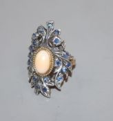 A 20th century continental? yellow and white metal mounted sapphire and cabochon coral upfinger