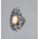 A 20th century continental? yellow and white metal mounted sapphire and cabochon coral upfinger