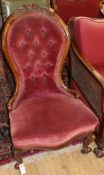 A Victorian walnut spoonback nursing chair