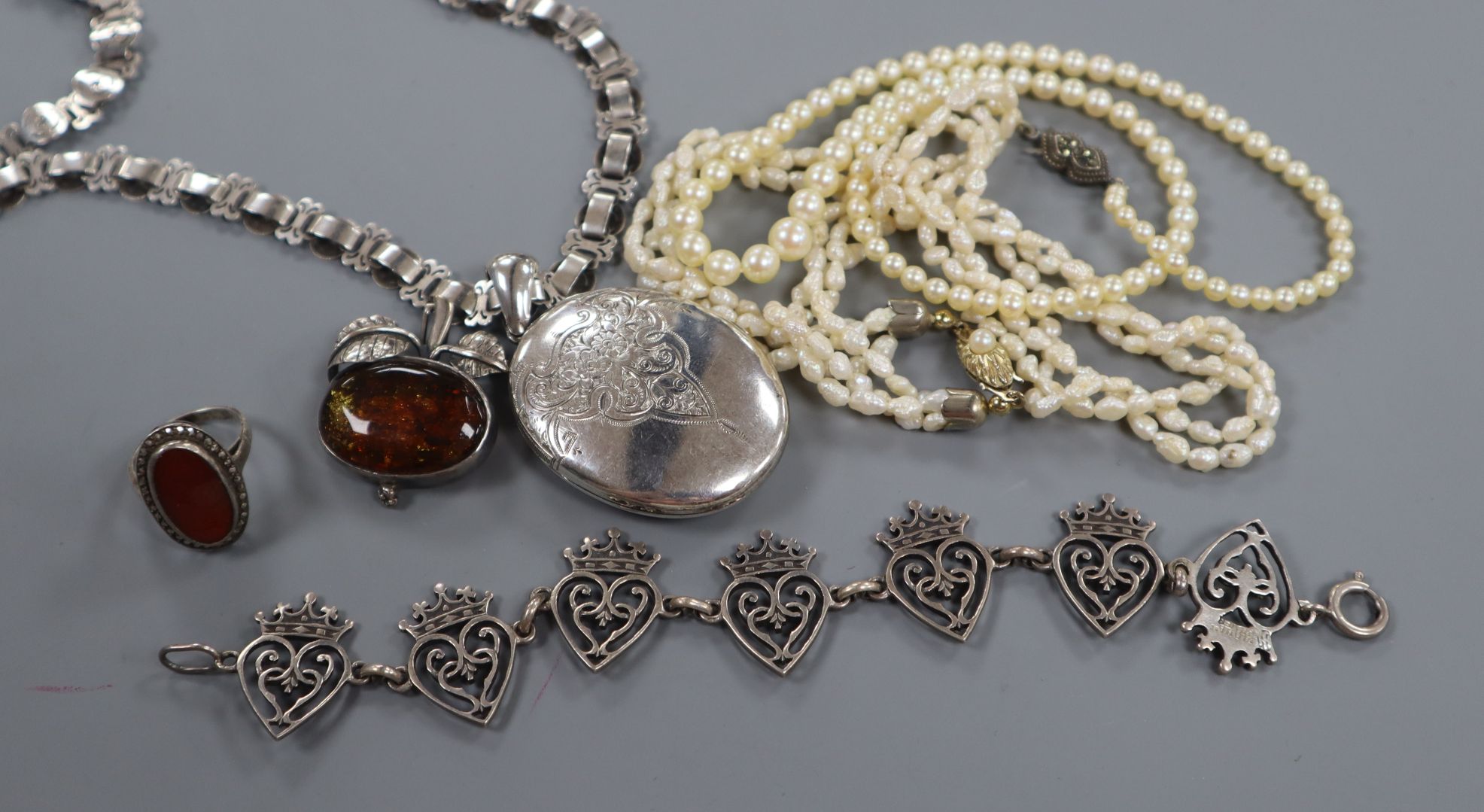 A white metal locket on chain, an Iona white metal bracelet, a brooch, a ring and two pearl