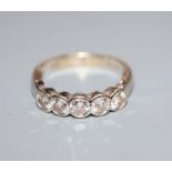 A modern 18ct white gold and five stone diamond half hoop ring, size O.