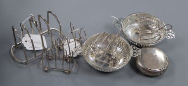 A set of four silver toast racks, another toast rack, a pair of George V pierced silver bon bon