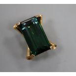 A yellow metal mounted (tests as 14ct) baguette cut green tourmaline clip brooch, the stone