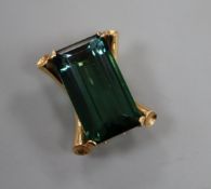 A yellow metal mounted (tests as 14ct) baguette cut green tourmaline clip brooch, the stone