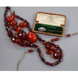 Simulated cherry amber including loose beads, necklace etc and two stick pins.