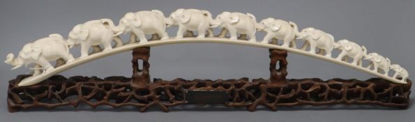 A Chinese carved ivory ten-elephant bridge on pierced carved hardwood stand, bearing presentation