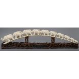 A Chinese carved ivory ten-elephant bridge on pierced carved hardwood stand, bearing presentation