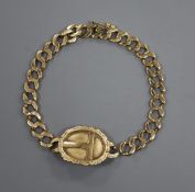 A yellow metal mounted curblink bracelet with engraved oval plaque(a.f.), engraved 14.
