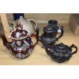 A bargeware treacle-glazed teapot (finial a.f.), a heavy stoneware teapot and three other items,
