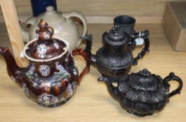 A bargeware treacle-glazed teapot (finial a.f.), a heavy stoneware teapot and three other items,