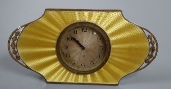 An Art Deco silver and yellow guilloche enamel desk clock with silvered Arabic dial in pierced